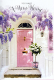 A peaceful Queen's Park doorway, caught in a moment of stillness, becomes the stage for a tender floral gesture welcoming someone to their new home. At the heart of the image stands a pale pink door, its tone soft and dusty rather than bright, giving the entrance a sense of understated charm. The surrounding walls are painted white, gently textured and washed with natural light, helping the pastel shades of the scene to feel airy and open. Overhead, established wisteria spills from an unseen vine, its blossoms tumbling in loose, lavender cascades that frame the doorway in a soft, organic arch. Each hanging strand is made up of tiny, clustered petals, creating a layered effect that looks almost like nature's own lace. On the step below, a rounded tin bucket rests firmly on the stone, filled with a generous bouquet of white and cream roses. The roses are densely packed, their velvety petals overlapping in spirals, some flowering wide and open while others remain gently cupped. Threads of fresh green foliage weave through the arrangement, adding subtle variation and a sense of vitality. Around the base of the bucket, a pink ribbon is tied in a simple, elegant bow, its satin surface catching faint highlights that tie it visually to the soft tones of the front door and the wisteria above. The light in the scene is tender and calm, reminiscent of an afternoon near Queen's Park itself, where tree-lined streets feel sheltered from the city beyond. The overall impression is one of hope and quiet celebration, ideal for a housewarming or congratulatory card, capturing how a thoughtfully placed arrangement can make a new address in NW6 feel instantly lived-in, loved, and truly welcoming.